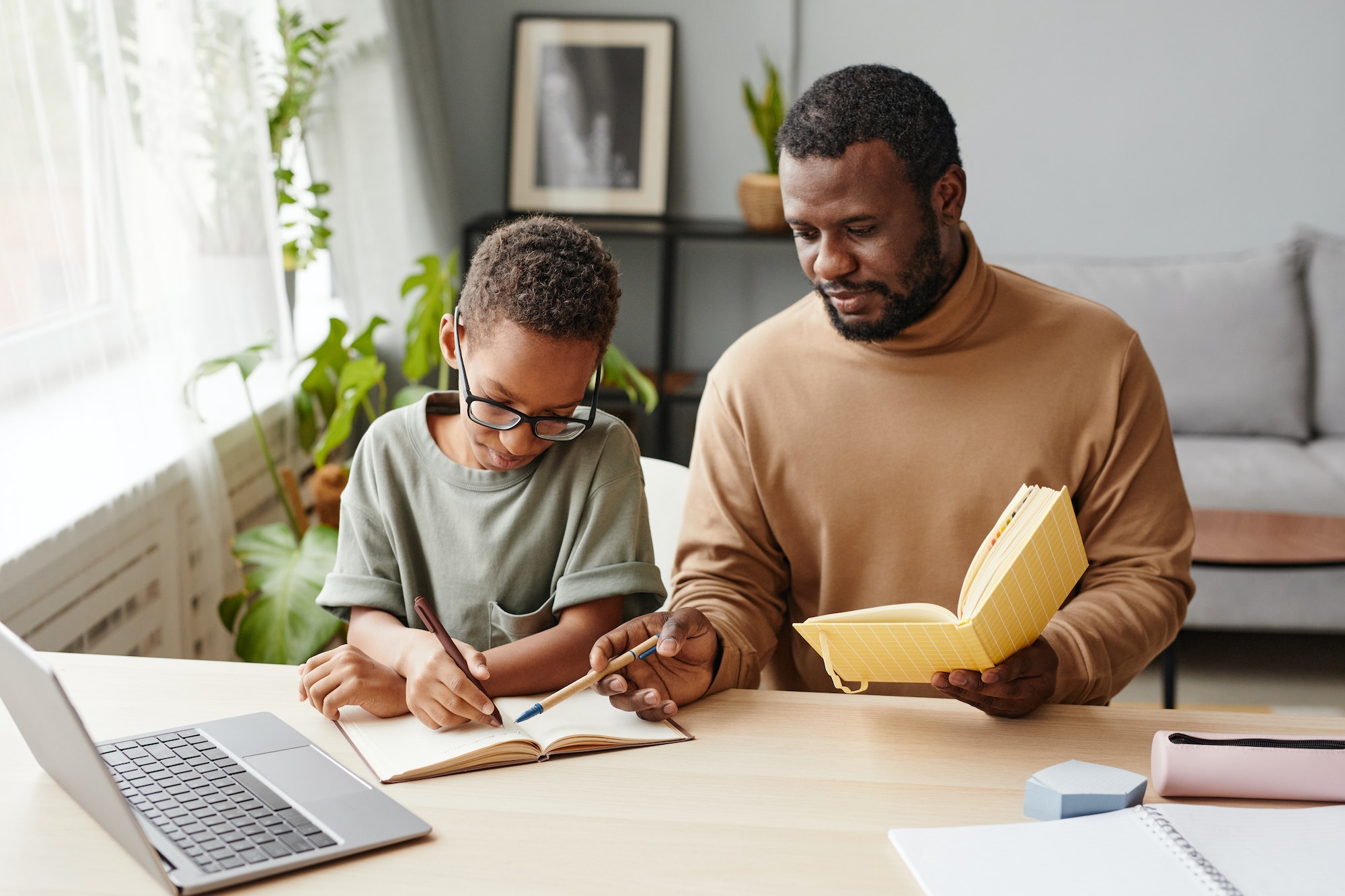 African American Father Helping Son Studying